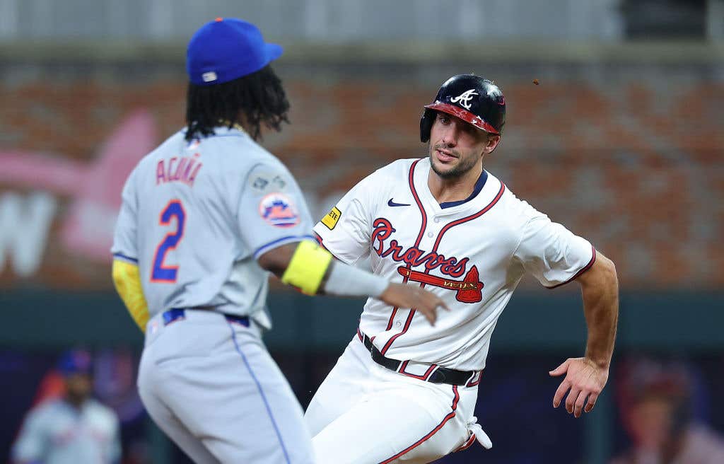 ATLANTA, GEORGIA: Matt Olson #28 of the Atlanta Braves advances around second base on a RBI single by Ramon Laureano #18 in the third inning against the New York Mets at Truist Park on September 24, 2024 in Atlanta, Georgia.