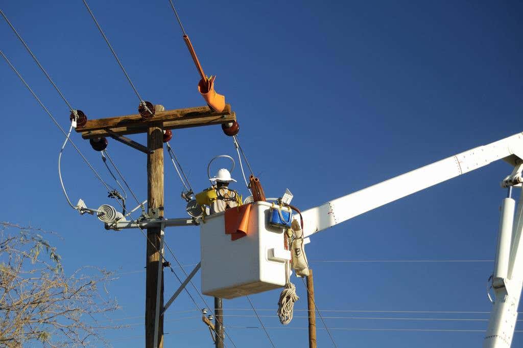 Hurricane Helene - Power Outages - Hazards -Electric utility lineman working on power lines.