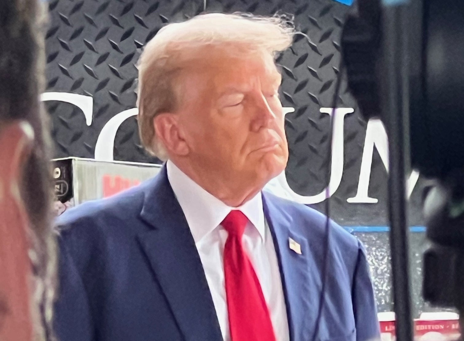 Presidential candidate Donald Trump listens as Governor Kemp addresses the press about Hurricane Helene recovery efforts on October 4, 2024.