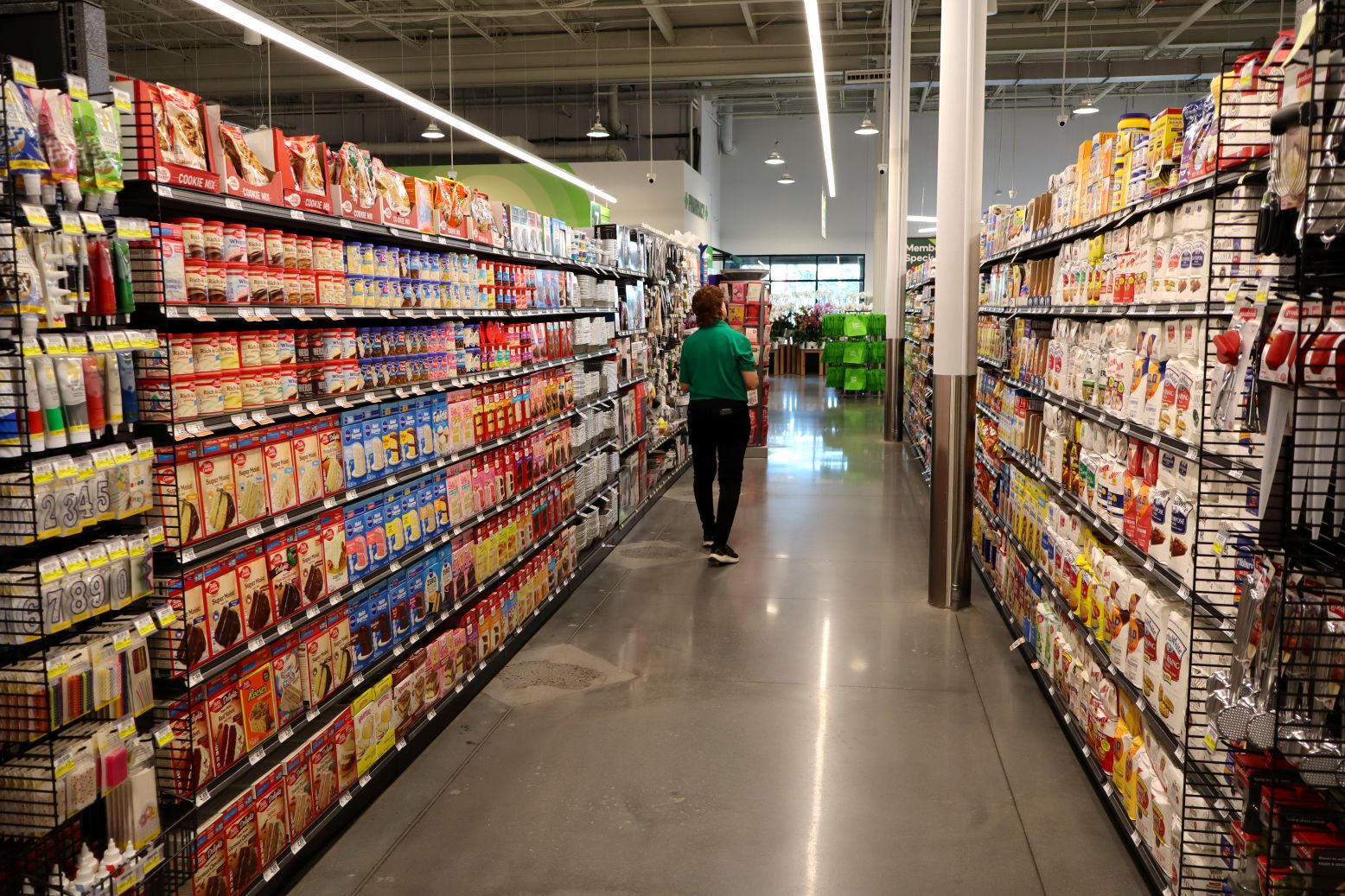 A FreshTake employee makes the final checks on one of the food aisles at the Augusta store. FreshTake combines a traditional grocery store with an elevated shopping experience. 