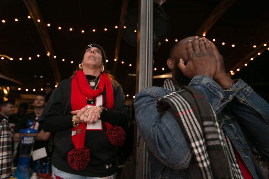 ATLANTA, GA: Atlanta Falcons fan Cesear Totten (R) covers his face as Lana Craddock watches the final play of the Super Bowl 51 against the New England Patriots at STATS on February 5, 2017 in Atlanta, Georgia.