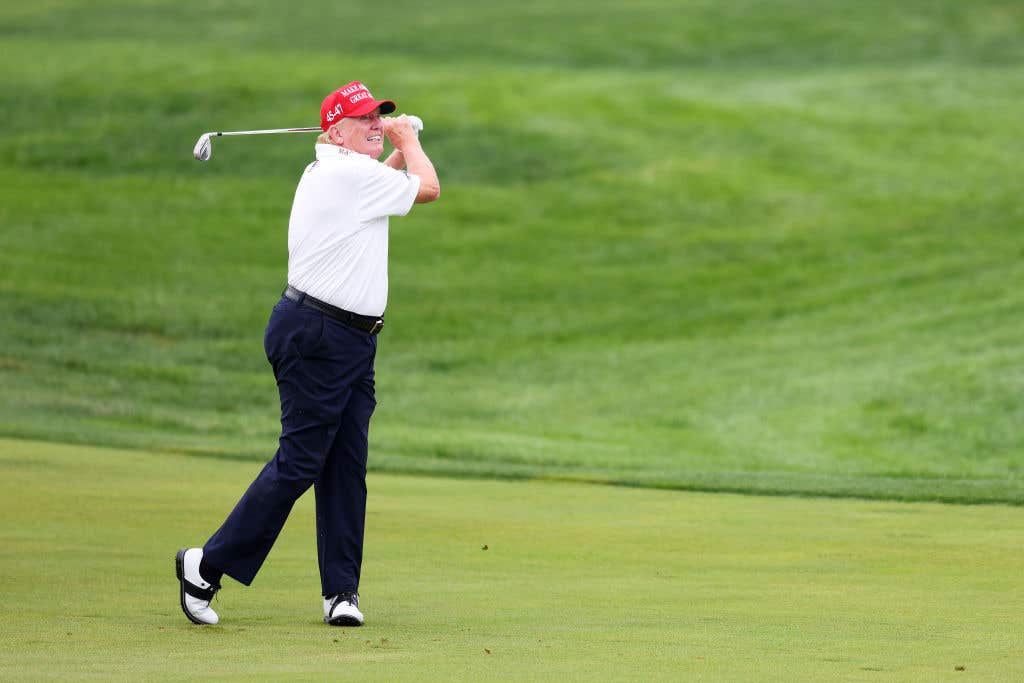 BEDMINSTER, NEW JERSEY: President Donald Trump hits his shot from the first fairway during the pro-am prior to the LIV Golf Invitational - Bedminster at Trump National Golf Club on August 10, 2023 in Bedminster, New Jersey. The president reportedly believes he can unite the PGA and LIV.