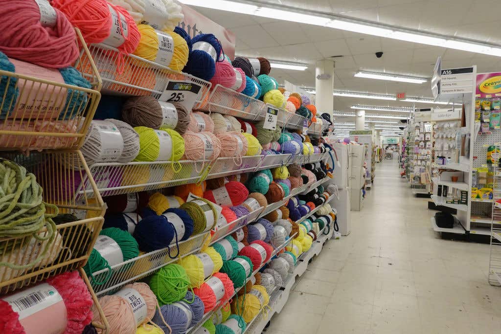 MIAMI, FLORIDA: Rolls of yarn fill a shelf in a JOANN Fabric and Crafts store slated to close on February 13, 2025 in Miami, Florida. The company announced it will be closing approximately 500 of its roughly 850 locations across the United States.