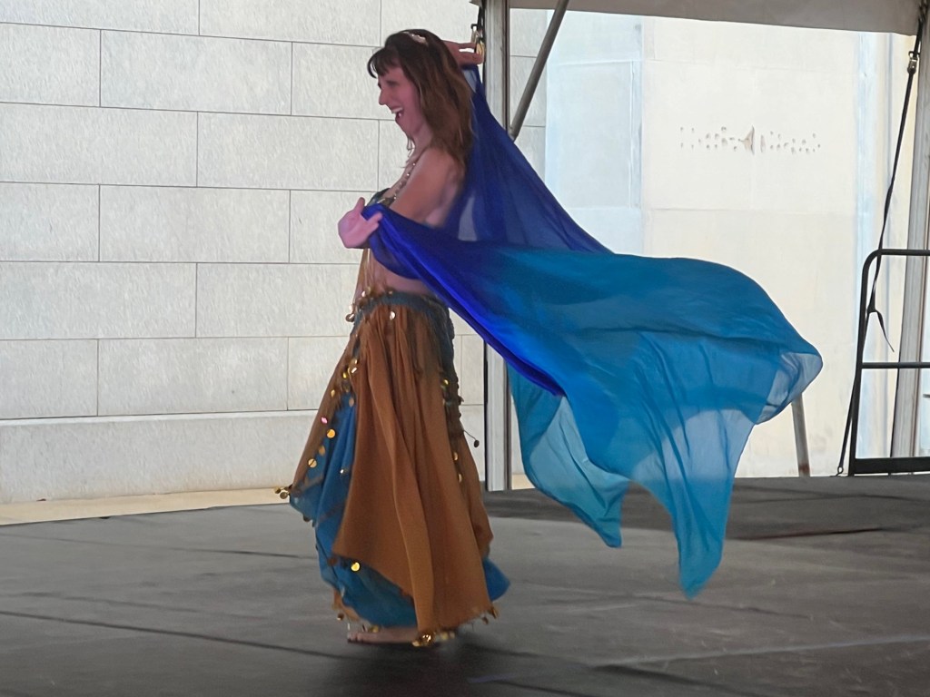 A dancer from the Savannah Winds Middle Eastern Dance Troupe entertains on the Family Stage at the 2024 Arts In the Heart of Augusta Festival.