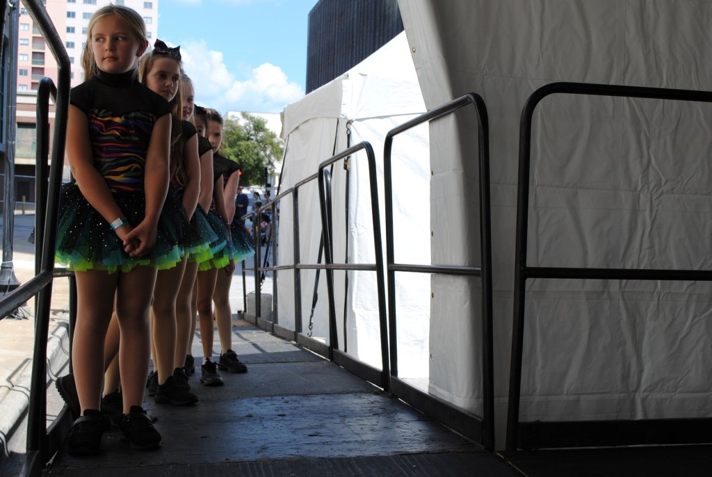 A group of young dancers waits to take the stage at the 2024 Arts In the Heart of Augusta Festival.