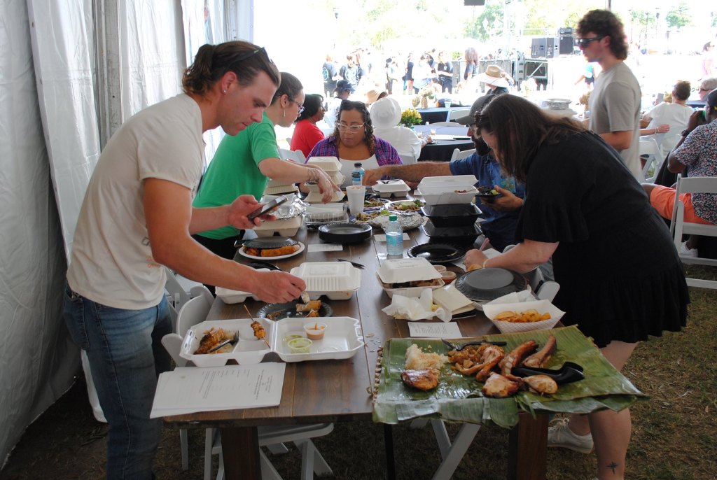 Judges begin the long and delicious process of tasting submissions from the 21 Global Food Village tents at the 2024 Arts In the Heart of Augusta Festival. This year's Best Meal winner was Jamaica for its Jerk Chicken with rice and beans.