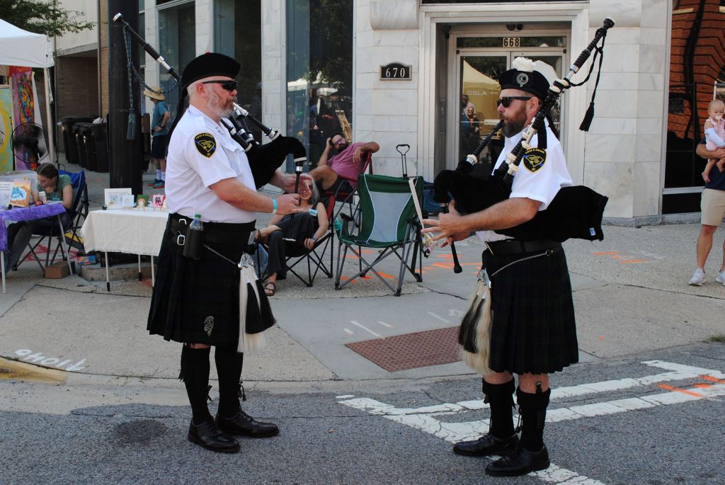 Pipers in tandem squeeze out a duet at the 2024 Arts In the Heart of Augusta Festival.