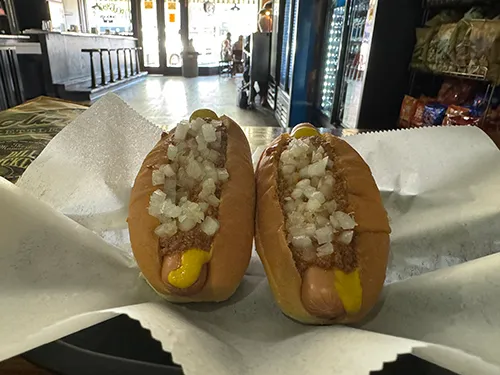 Hot dogs with mustard, onions and chili. Rough House is a mandatory stop for any hot dog aficionado.