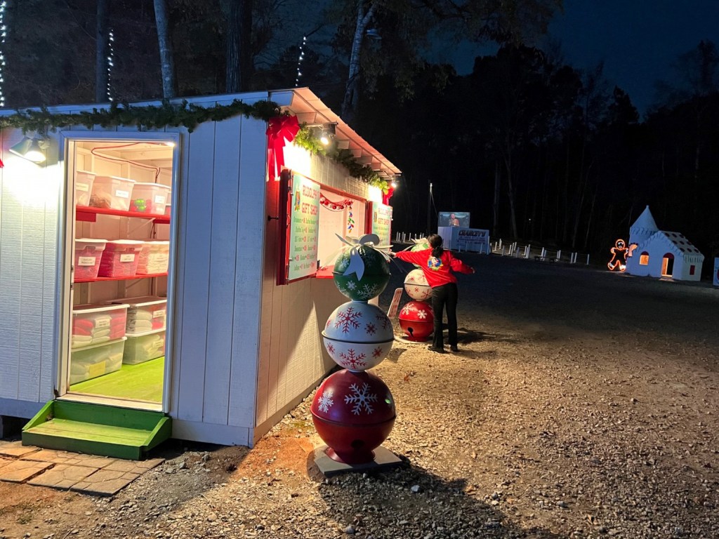 An employee readies Rudolph's Gift Shop prior to the gates opening at Lights of the South.